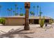 Single-story home with stone exterior,desert landscaping, and a two-car garage at 12059 S Paiute St, Phoenix, AZ 85044