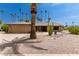 Tan house exterior with rock accents and palm trees at 12059 S Paiute St, Phoenix, AZ 85044