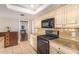 Updated kitchen featuring granite countertops and modern appliances at 12059 S Paiute St, Phoenix, AZ 85044