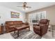 Living room with brown leather furniture and wood coffee table at 12059 S Paiute St, Phoenix, AZ 85044