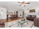 Spacious living room features hardwood floors, a ceiling fan, and comfortable seating at 12059 S Paiute St, Phoenix, AZ 85044