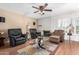 Bright living room with a fireplace, hardwood floors, and comfortable seating at 12059 S Paiute St, Phoenix, AZ 85044