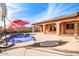 Relaxing backyard oasis with a pool, patio, and covered seating area at 12061 W Miner Trl, Peoria, AZ 85383