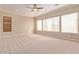 Spacious bedroom with large windows and carpeted floor at 12061 W Miner Trl, Peoria, AZ 85383