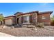 Single-story home with stone accents and a three-car garage at 12061 W Miner Trl, Peoria, AZ 85383