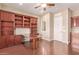 Home office with built-in wooden shelves and desk, near entry at 12061 W Miner Trl, Peoria, AZ 85383