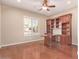 Bright home office with built-in wooden shelves and desk at 12061 W Miner Trl, Peoria, AZ 85383