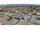 Aerial view of a luxury home with a pool, sports court, and desert landscape at 12075 N 76Th Ct, Scottsdale, AZ 85260