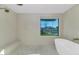 Spa-like bathroom with soaking tub and backyard view at 12075 N 76Th Ct, Scottsdale, AZ 85260