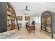 Spacious home office with built-in bookshelves and hardwood floors at 12075 N 76Th Ct, Scottsdale, AZ 85260