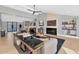 Open concept living room with fireplace and built-in shelving at 12075 N 76Th Ct, Scottsdale, AZ 85260