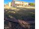 Large backyard with grassy area, brick border, and partial view of home at 12419 W Monte Vista Rd, Avondale, AZ 85392