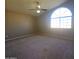 Spacious bedroom with ceiling fan and arched window at 12419 W Monte Vista Rd, Avondale, AZ 85392