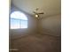 Cozy bedroom with ceiling fan and arched window at 12419 W Monte Vista Rd, Avondale, AZ 85392