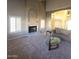 Living room with fireplace, vaulted ceiling, and neutral decor at 12419 W Monte Vista Rd, Avondale, AZ 85392