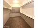 Large walk-in closet with shelving and hanging rods at 12419 W Monte Vista Rd, Avondale, AZ 85392