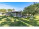 Home's backyard features a screened patio and lush lawn with orange trees at 12539 W Shadow Hills Dr, Sun City West, AZ 85375