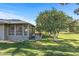 Backyard oasis with a screened patio, mature orange trees, and grassy area at 12539 W Shadow Hills Dr, Sun City West, AZ 85375