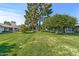 Green lawn and mature trees in the backyard at 12539 W Shadow Hills Dr, Sun City West, AZ 85375