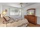 Bright bedroom with wooden dresser and laminated flooring at 12539 W Shadow Hills Dr, Sun City West, AZ 85375