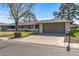 House exterior showcasing a gray garage door and landscaping at 12539 W Shadow Hills Dr, Sun City West, AZ 85375