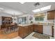 Kitchen with breakfast bar, wood cabinets, and dining area view at 12539 W Shadow Hills Dr, Sun City West, AZ 85375