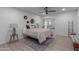 Bright bedroom featuring a comfortable bed and ceiling fan at 13614 N Hawthorn Dr, Sun City, AZ 85351