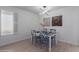 Bright dining area with gray table and chairs, decorative wall art, and wood floors at 13614 N Hawthorn Dr, Sun City, AZ 85351