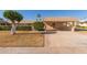 Tan single-story home with carport and nicely landscaped front yard at 13614 N Hawthorn Dr, Sun City, AZ 85351