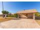 View of the carport and front entrance of the house at 13614 N Hawthorn Dr, Sun City, AZ 85351