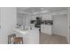 Modern white kitchen with island, new appliances, and dark green tile backsplash at 13614 N Hawthorn Dr, Sun City, AZ 85351