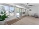 Bright sunroom with sliding glass doors, a ceiling fan, and a view of the backyard at 13614 N Hawthorn Dr, Sun City, AZ 85351