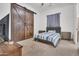 Bedroom with gray bed and barn door at 13648 E Aloe Vera Dr, Scottsdale, AZ 85262