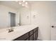 Bathroom with vanity, mirror, and dark brown cabinets at 14238 W Bronco Trl, Surprise, AZ 85387