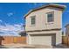 Attached garage with light-colored door at 14238 W Bronco Trl, Surprise, AZ 85387