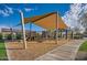 Shaded playground with play structures and soft ground at 14238 W Bronco Trl, Surprise, AZ 85387