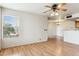 Living room with wood floors, sliding glass door to balcony, and a ceiling fan at 14645 N Fountain Hills Blvd # 217, Fountain Hills, AZ 85268