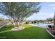 Artificial turf backyard with a pool, waterfall feature, and mountain views at 15020 E Sierra Madre Dr, Fountain Hills, AZ 85268