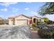 Two-car garage and desert landscaping with a tan colored house at 15020 E Sierra Madre Dr, Fountain Hills, AZ 85268