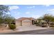 Tan house with tile roof, two car garage, and landscaping at 15020 E Sierra Madre Dr, Fountain Hills, AZ 85268