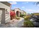 Tan colored house with red flowers, a walkway, and rock landscaping at 15020 E Sierra Madre Dr, Fountain Hills, AZ 85268