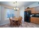 Kitchen nook with a wood table and chairs, along with a view of the kitchen at 16549 W Desert Ln, Surprise, AZ 85388