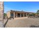 View of backyard with covered patio and gravel at 16935 W Villagio Dr, Surprise, AZ 85387