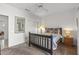 Bright bedroom featuring a ceiling fan and mirror at 16935 W Villagio Dr, Surprise, AZ 85387