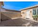 Private courtyard with a door and gravel at 16935 W Villagio Dr, Surprise, AZ 85387