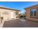 Inviting courtyard with gravel pathway, connecting the home's exterior and entry at 16935 W Villagio Dr, Surprise, AZ 85387