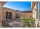 Private courtyard with gravel and a sliding glass door at 16935 W Villagio Dr, Surprise, AZ 85387