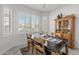 Charming dining area with wood table and hutch, near kitchen at 16935 W Villagio Dr, Surprise, AZ 85387