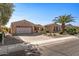 Two-car garage and desert landscaping with cactus plants at 16935 W Villagio Dr, Surprise, AZ 85387