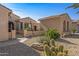 Front entry with desert landscaping and a gated walkway at 16935 W Villagio Dr, Surprise, AZ 85387